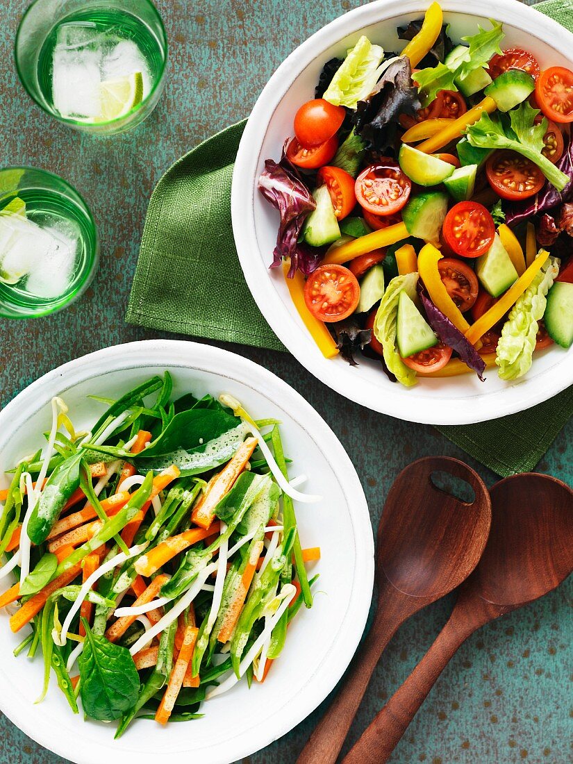 A carrot and mange tout salad and a tomato and cucumber salad