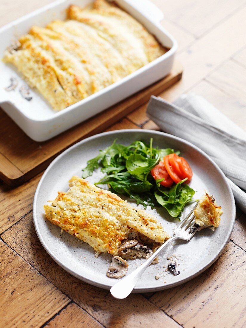Gratinated pancakes with cheese and mushrooms