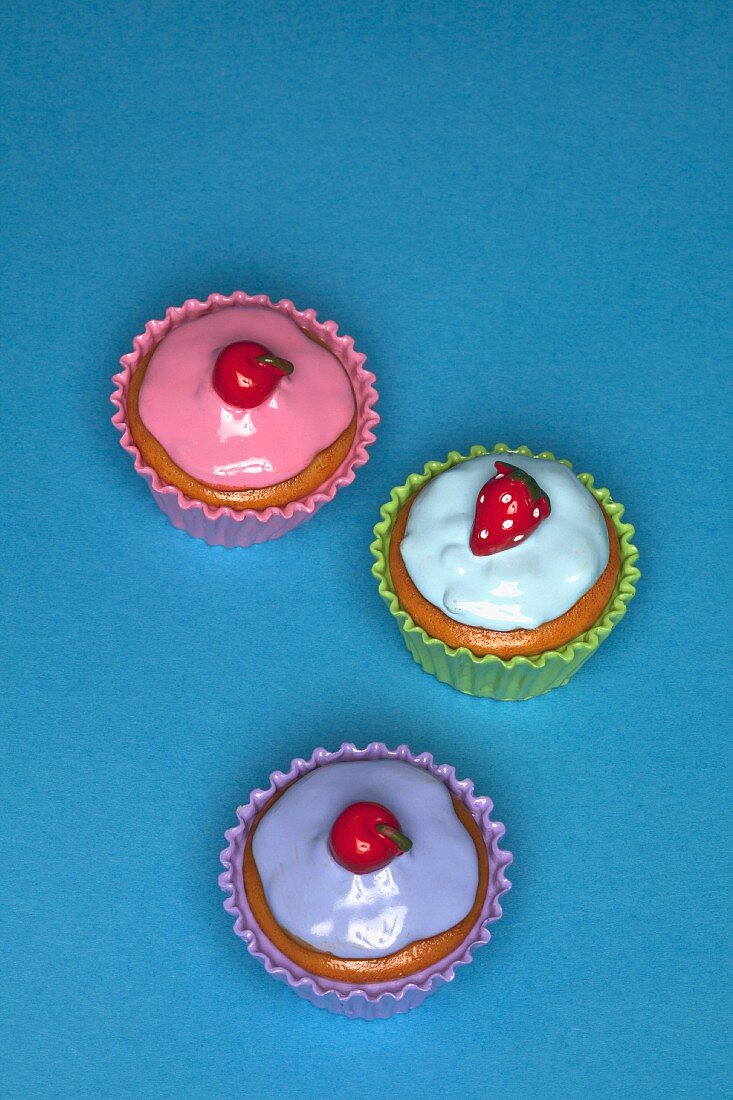 Colourful cupcakes on a blue surface