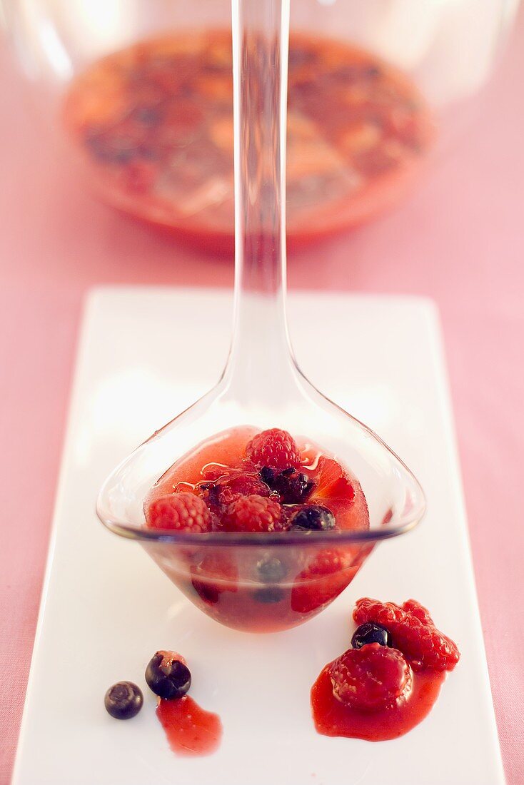Berry punch on a ladle and in a glass bowl