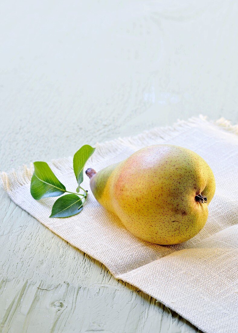 A fresh pear with leaves