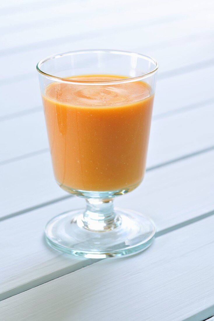 A glass of cream of carrot soup