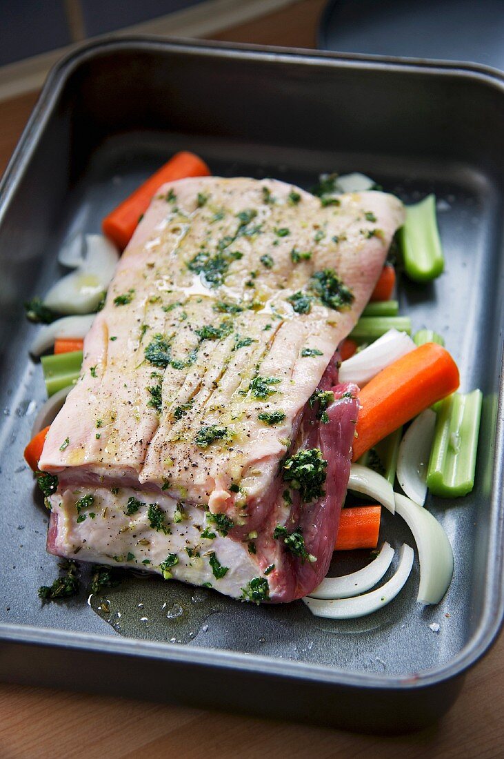 Pork belly with parsley and vegetables being prepared