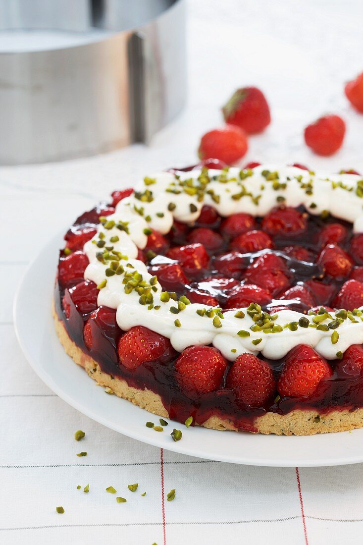 Strawberry cake with jelly, cream and pistachios