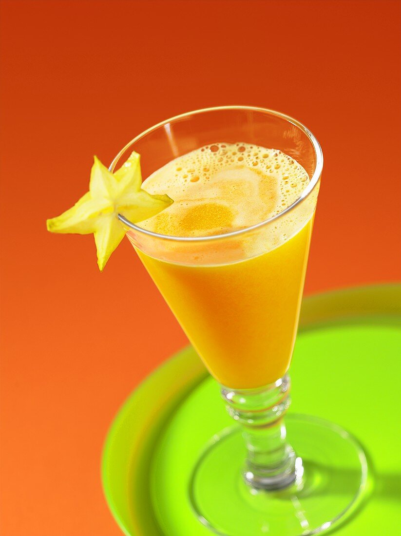 Orange and melon juice with a star fruit slice