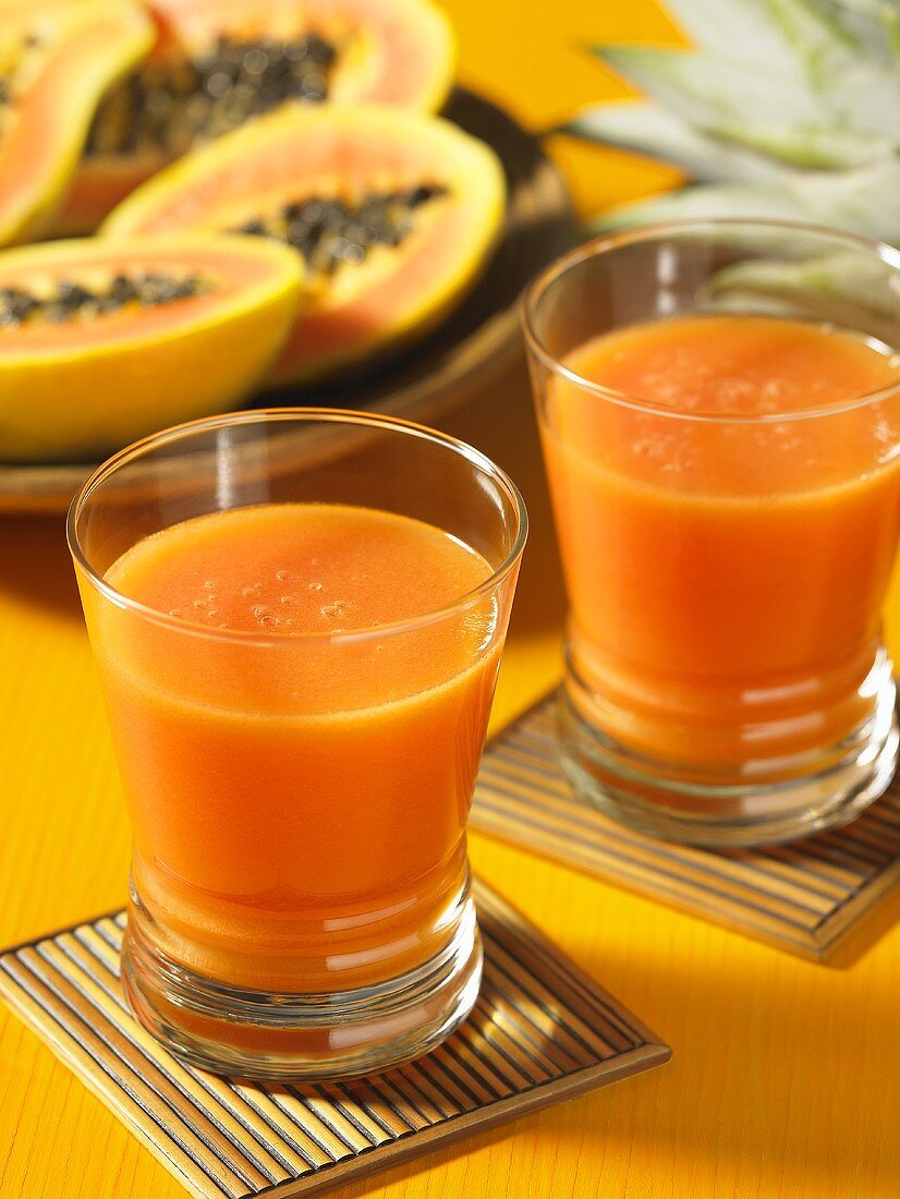 Two glasses of papaya and apple juice