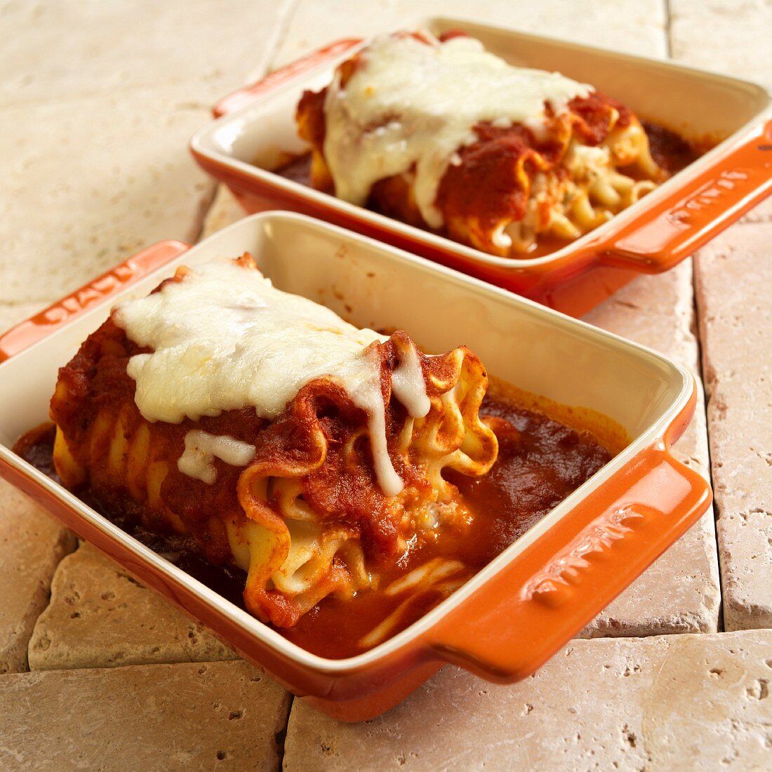 Rolled Cheese Lasagna with Marinara Sauce and Melted Mozzarella in Casserole Dishes