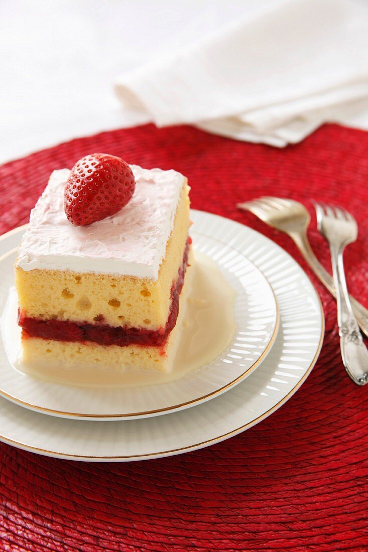 Piece of Tres Leches Cake with a Strawberry Layer; Two Forks