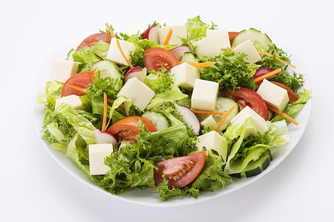 Green Salad with Cubes of Cheese; White … – License Images – 11001224 ❘  StockFood