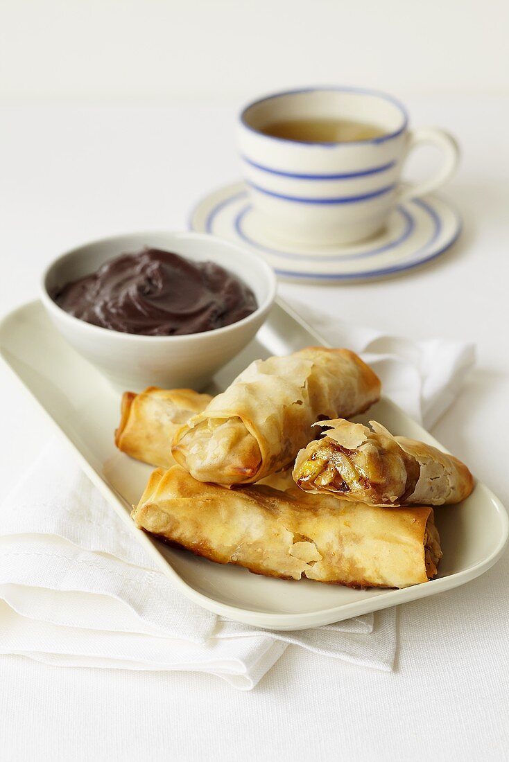 Sweet spring rolls filled with banana and served with a chocolate dip