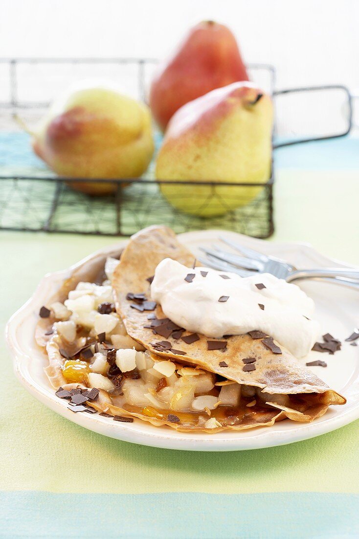 Pancakes filled with pears, chocolate and cream