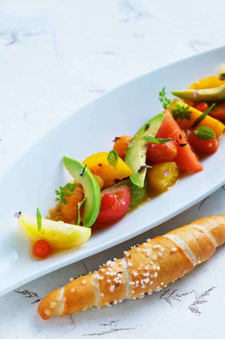 Tomato salad with avocado and salty bread