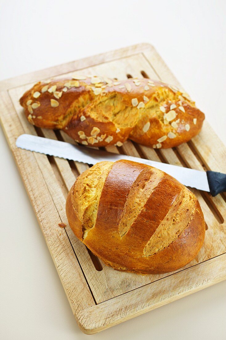 Two types of brioche on a wooden board