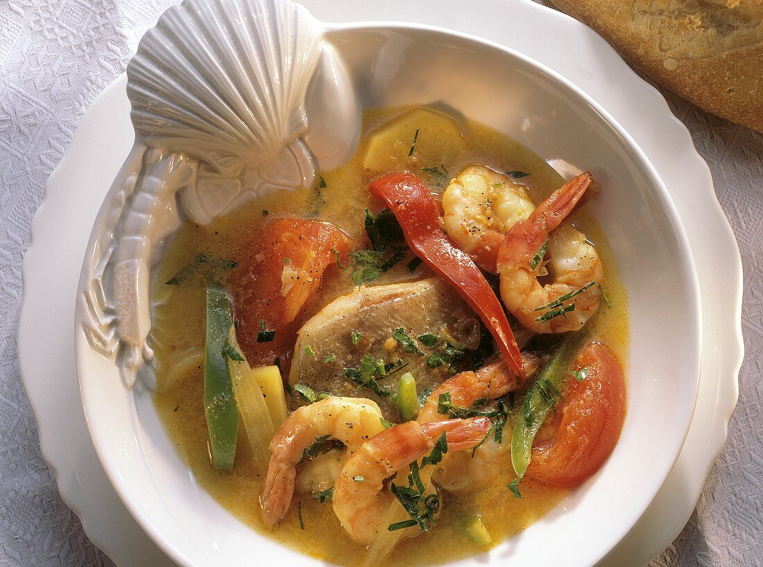 Fish soup with fish fillet, prawns and vegetables