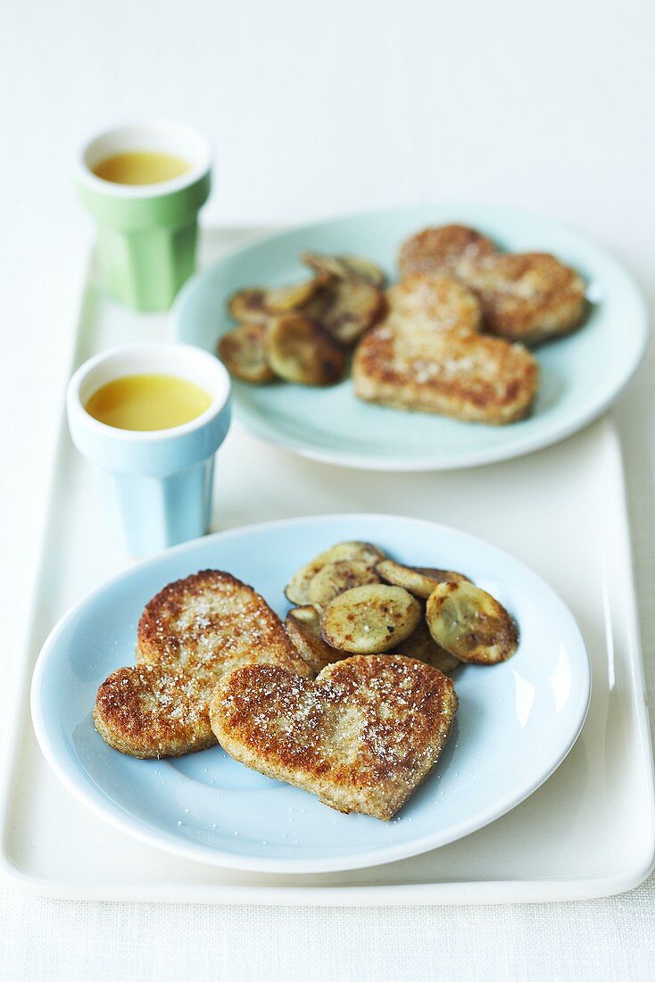 Heart-shaped French toast with fried banana slices