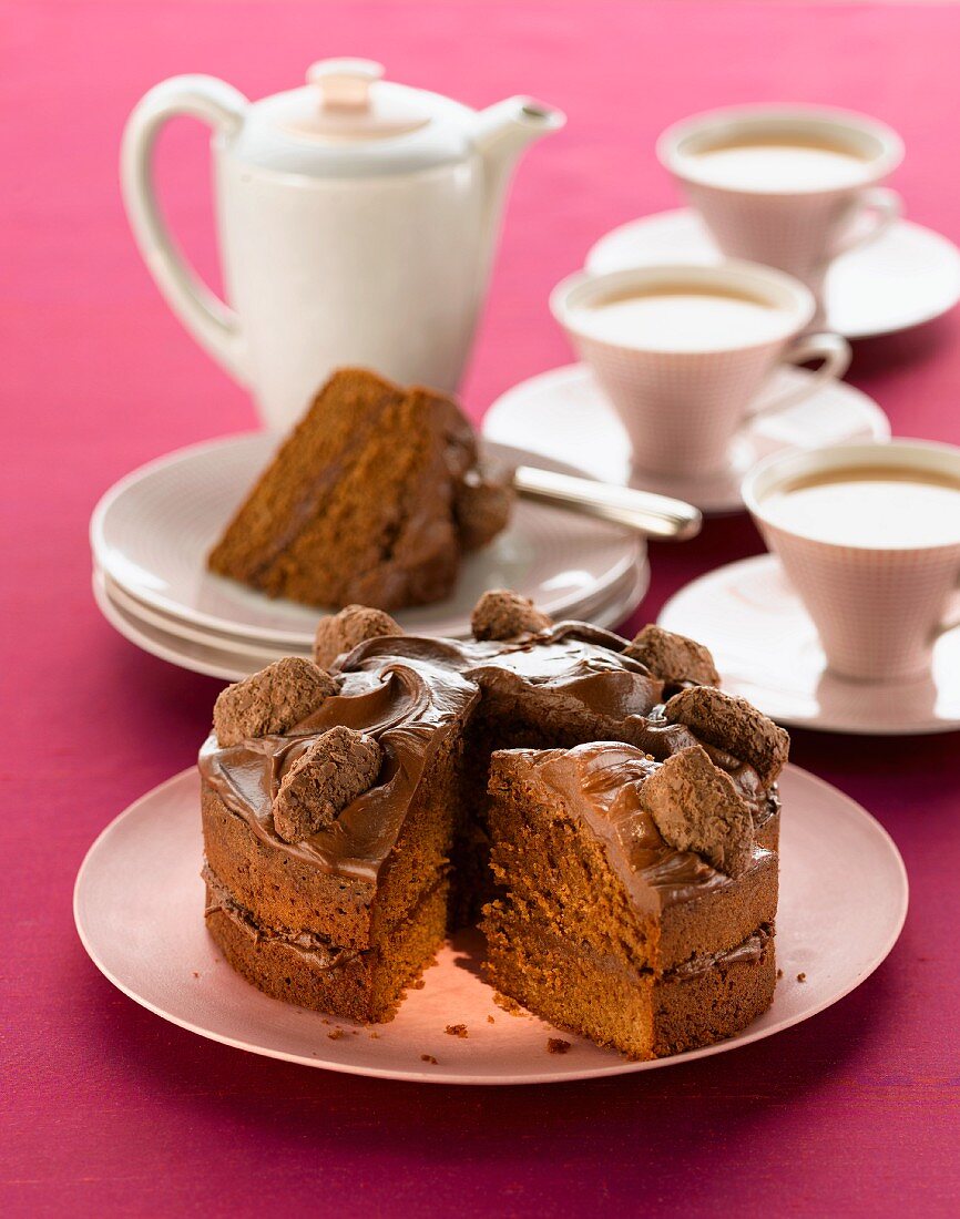 Chocolate cake and cups of tea