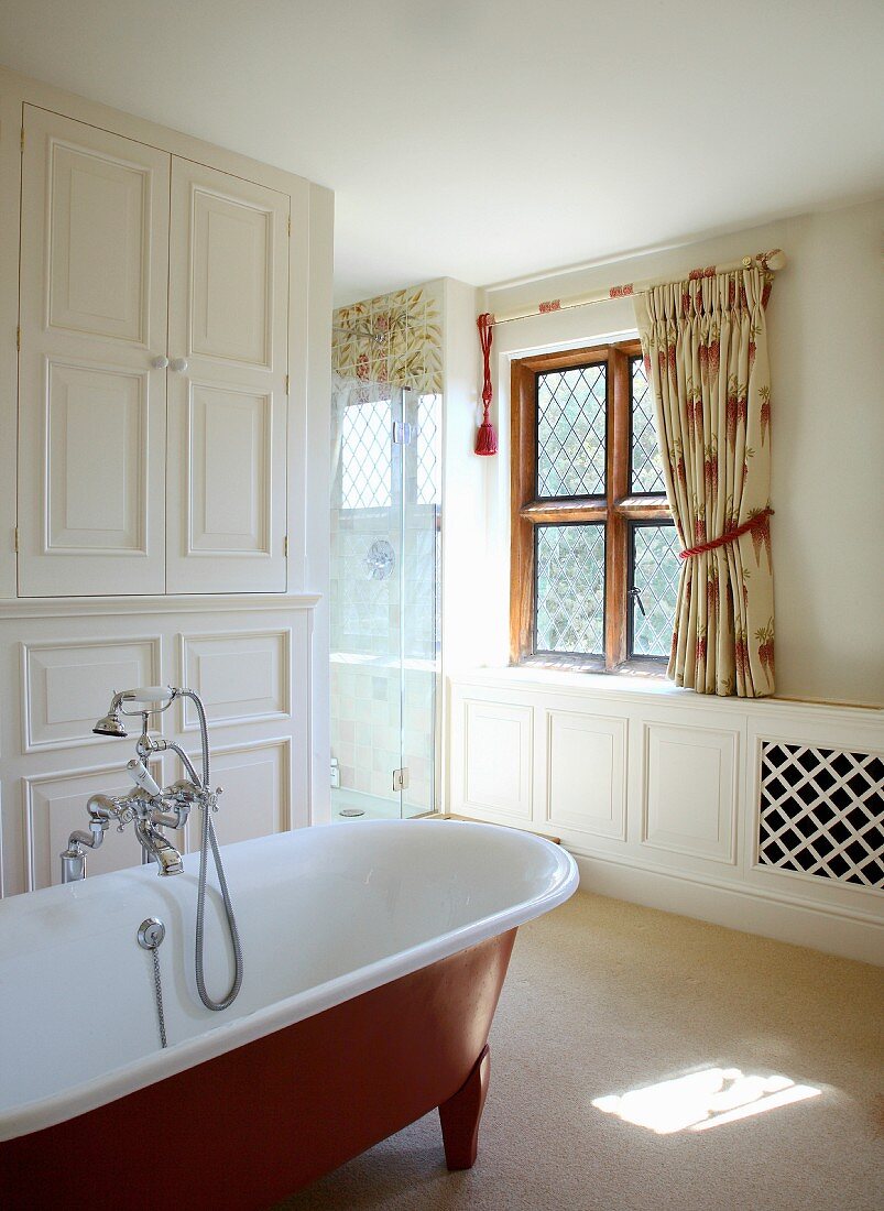 Free standing bathtub with a vintage look in a white, traditional bathroom