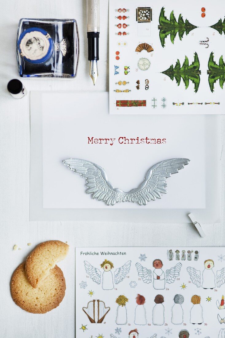 Various Christmas cards, a fountain pen and a biscuit