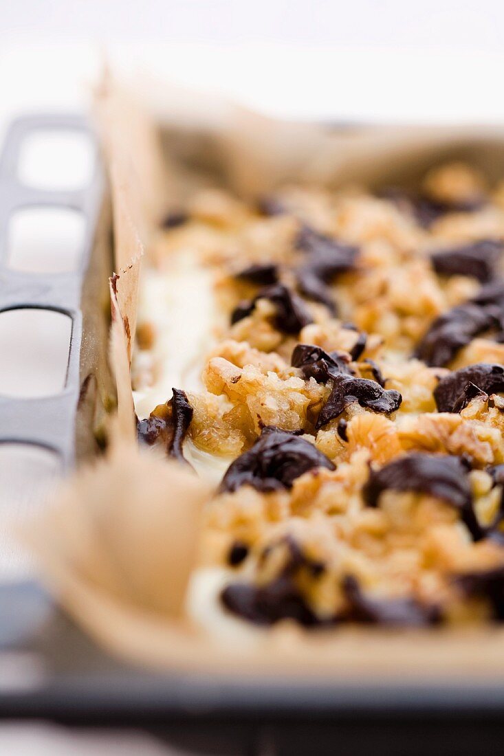 A chocolate crumble cake on a baking tray