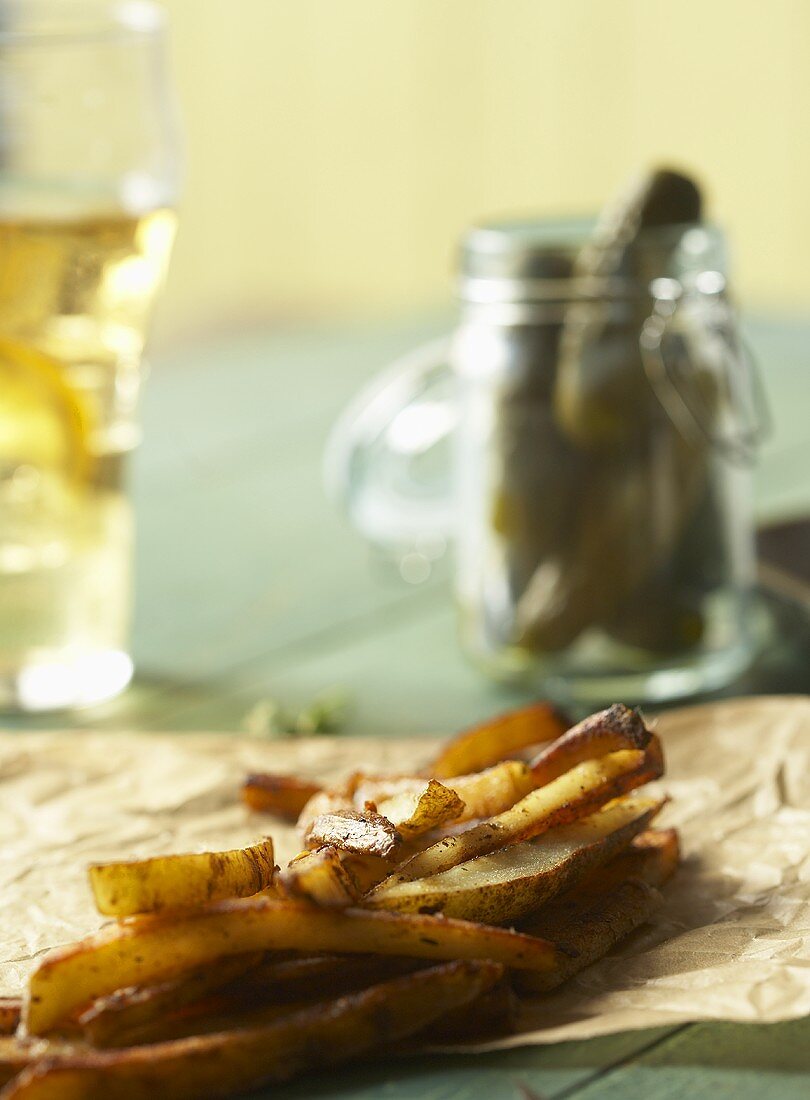 Fries on Parchment Paper; Jar of Pickles; Glass of Beer