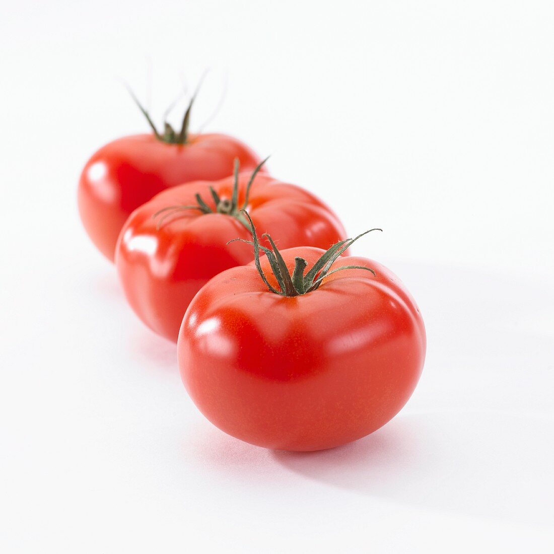 Three tomatoes (Lycopersicon Esculentum)