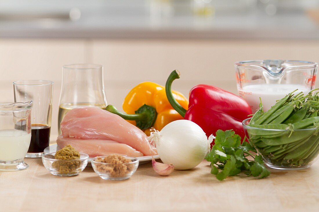 Ingredients for chicken curry (chicken breast, vegetables and spices)
