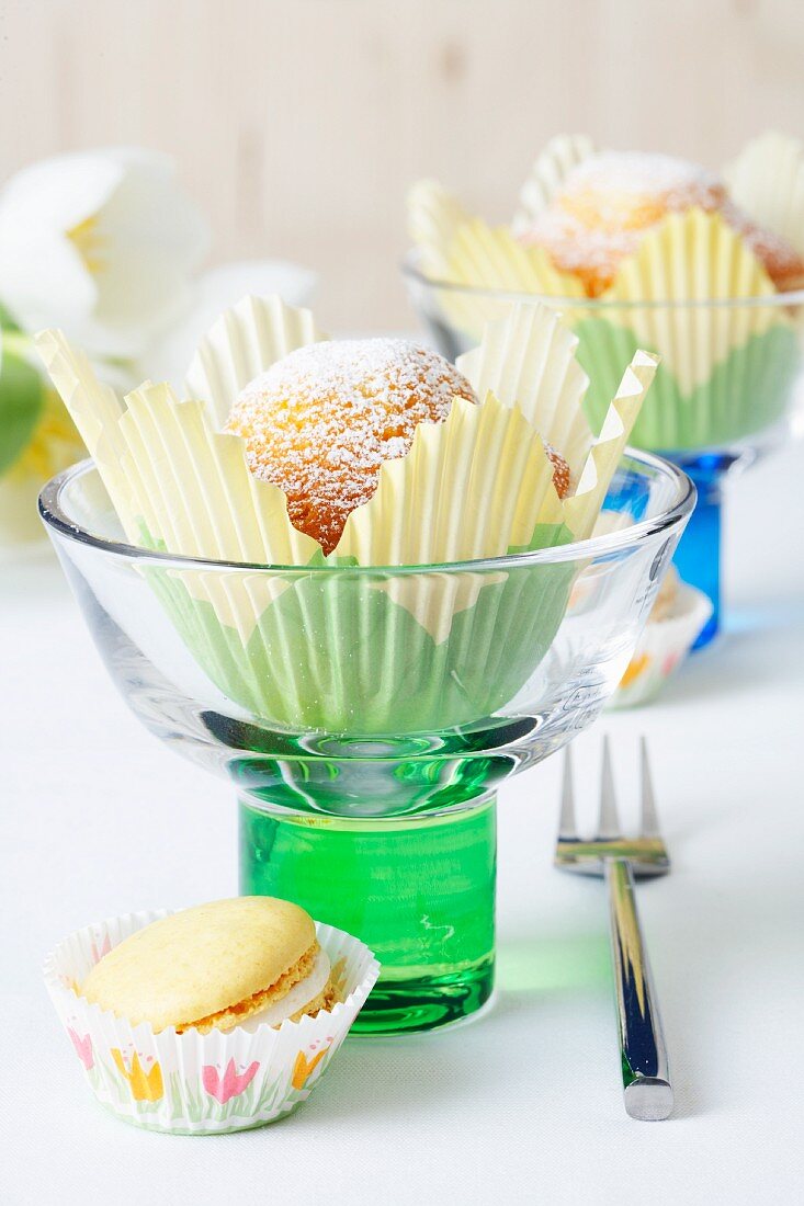 Muffins in tulip-shaped paper cases in ice cream sundae glasses