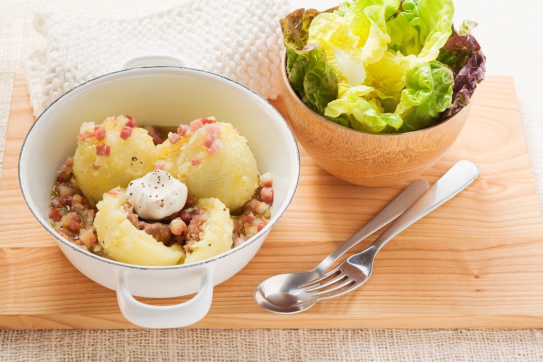 Potato dumplings in bacon sauce with a green salad (Lithuania)