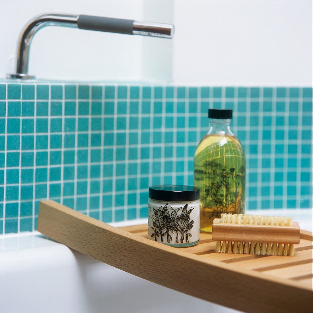 Bathing utensils on a shelf across a bath tub