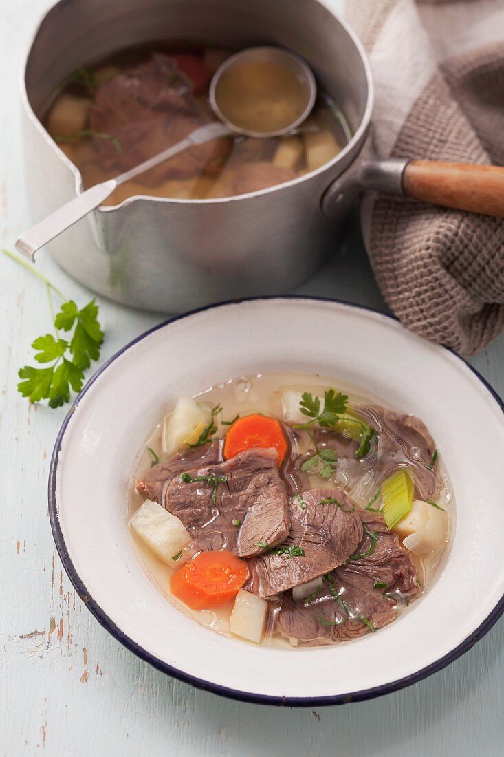 Beef short rib with vegetables in a clear broth