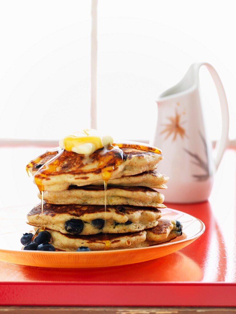 Pancakes with blueberries, butter and maple syrup
