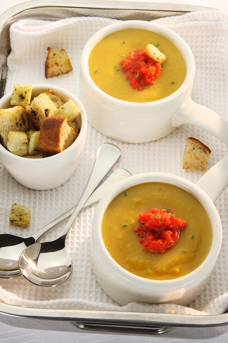 Butternut squash soup with puréed peppers and croutons