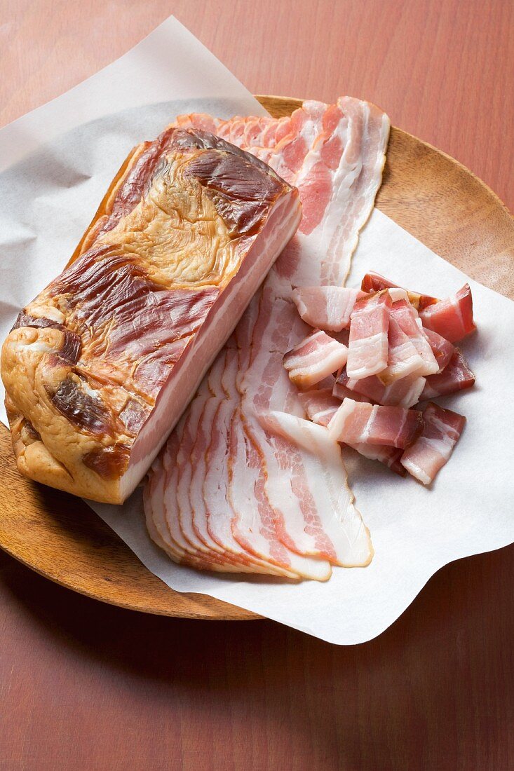 A slab of breakfast bacon, in rashers and diced