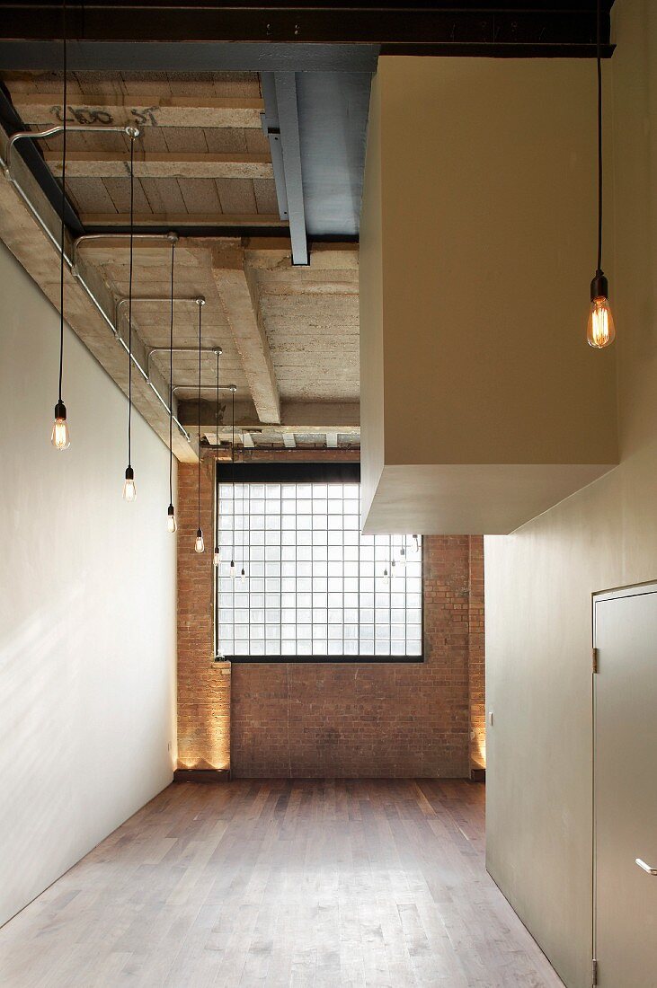 English loft with industrial window in brick wall and interlocking, white cubist structures