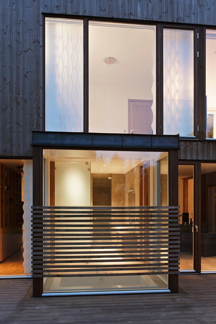 Facade of a contemporary house with illuminated windows