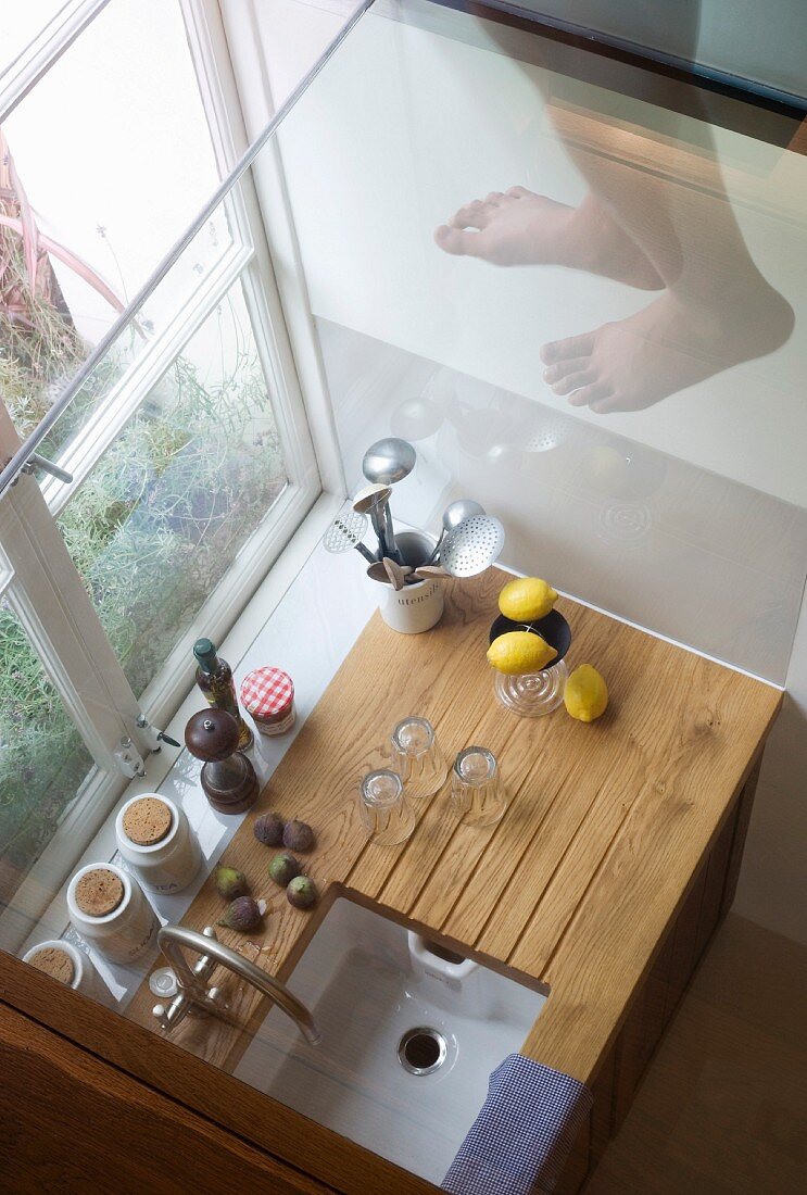 Looking down onto tiny kitchen unit with kitchen implements in window niche