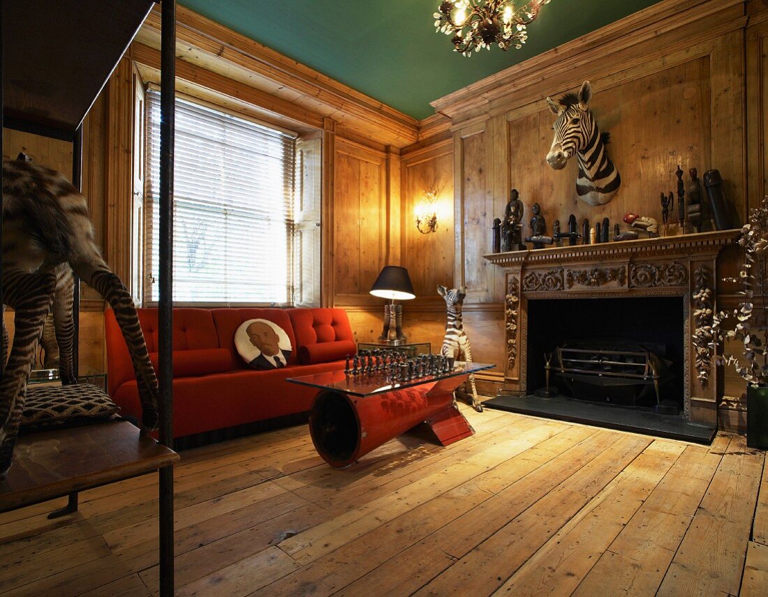 Animal trophies above fireplace in rustic, modern salon