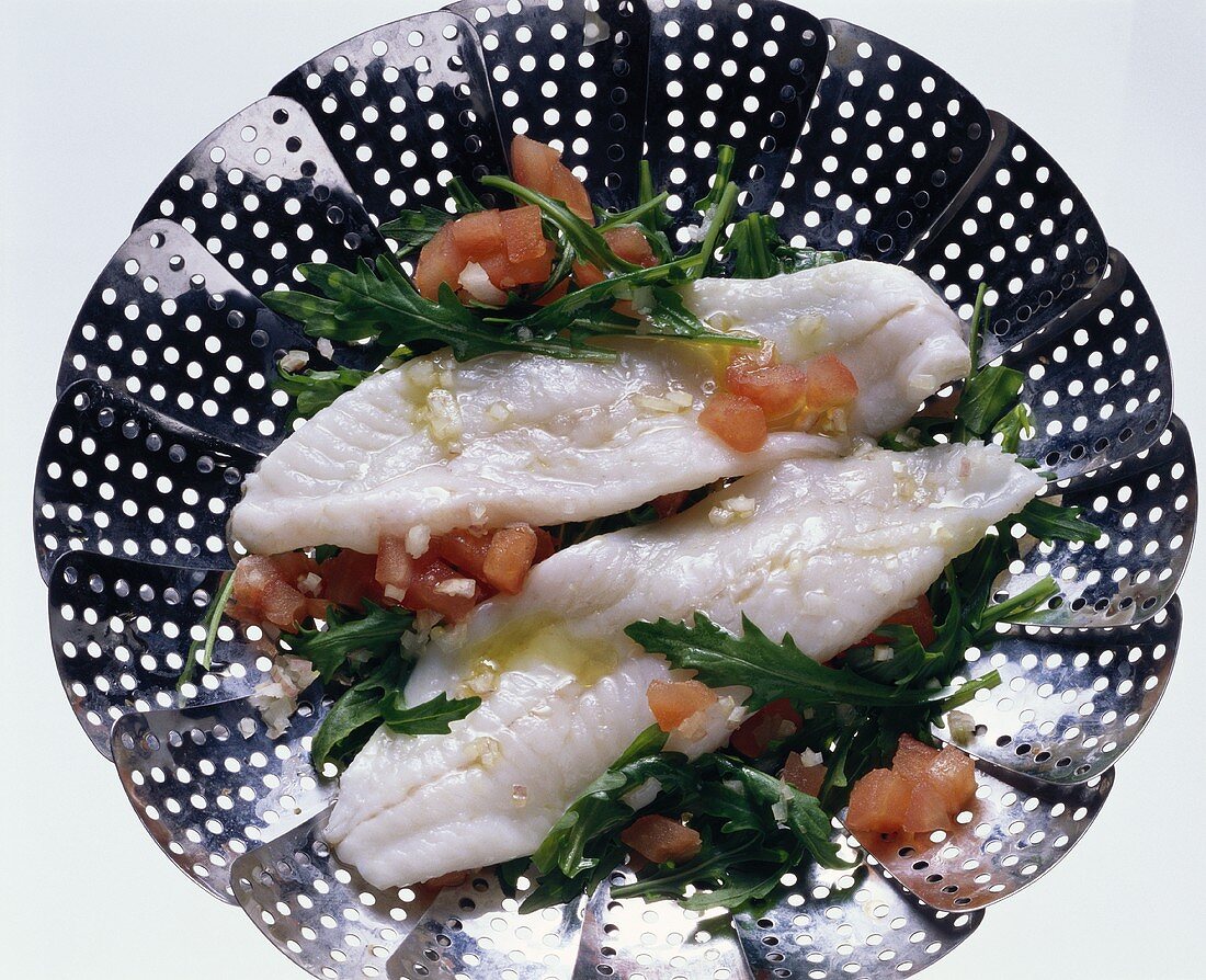 Turbot fillets with arugula & tomatoes in a steamer
