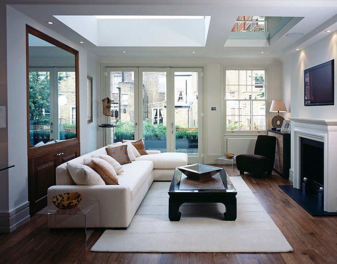 Chinese-style coffee table in front of sofa and view of neighbouring houses in English city house