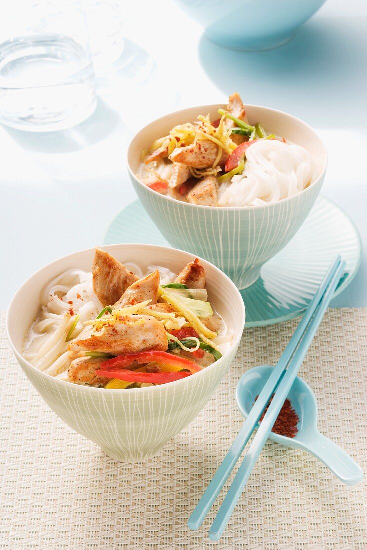 Oriental coconut soup with rice noodles, chicken and vegetables