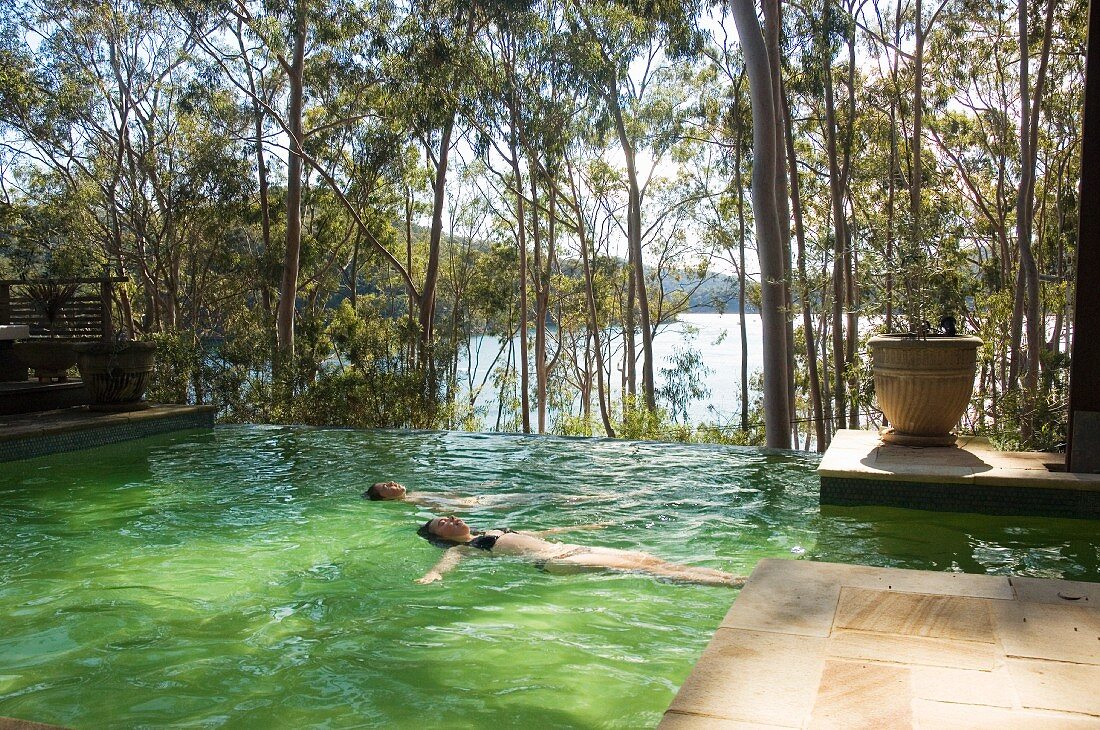 Two people swimming in pool