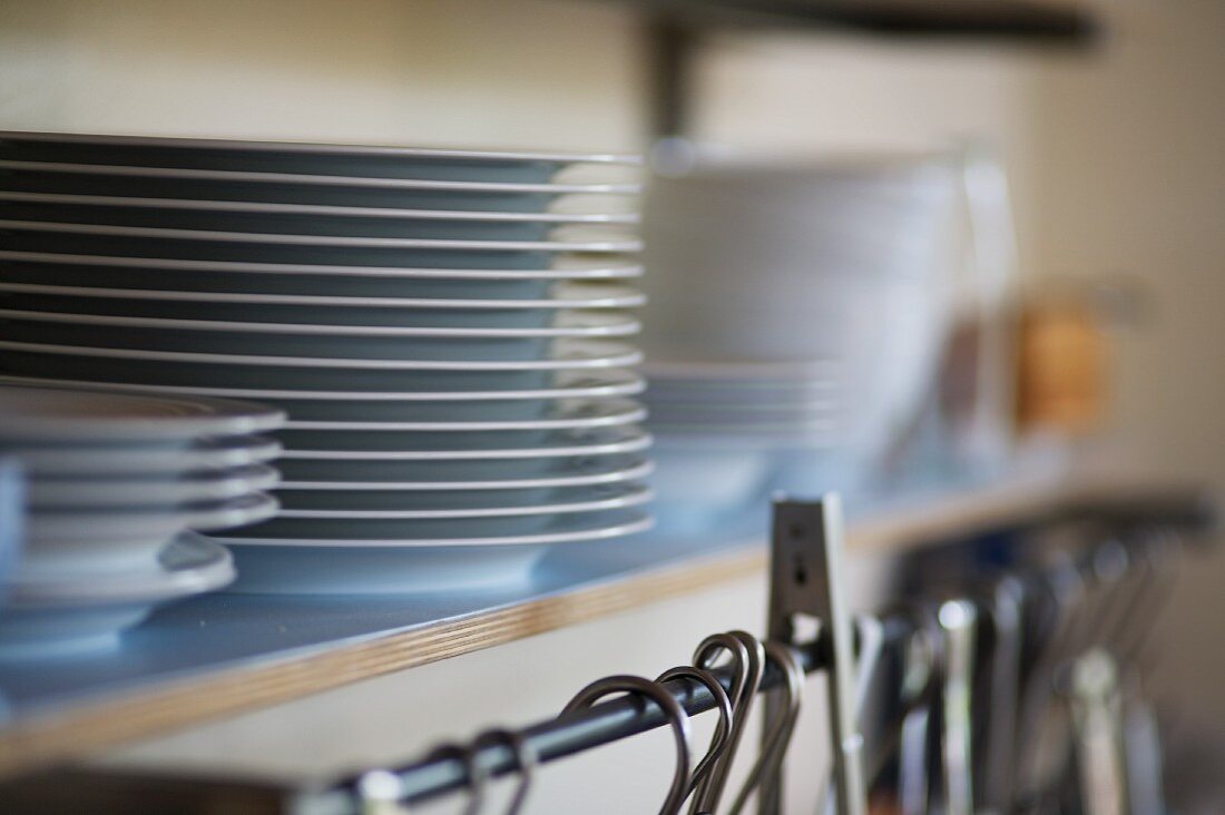 A stack of plates on a shelf