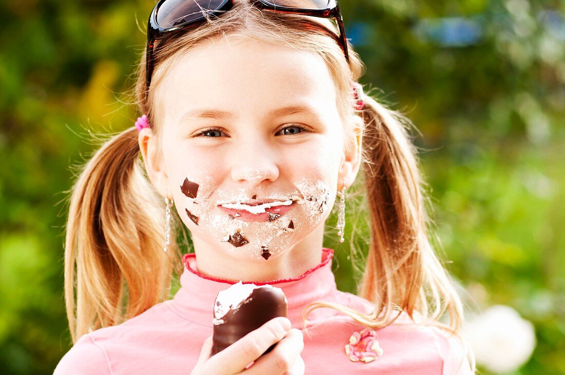 A girl eating a chocolate marshmallow