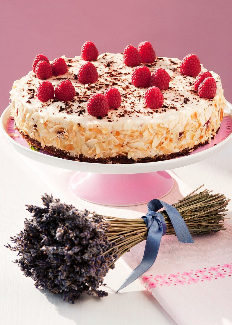 A raspberry cream cake on a cake stand