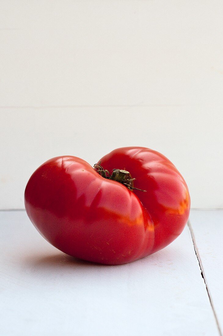 Whole Tomato on an Orange Dish Towel