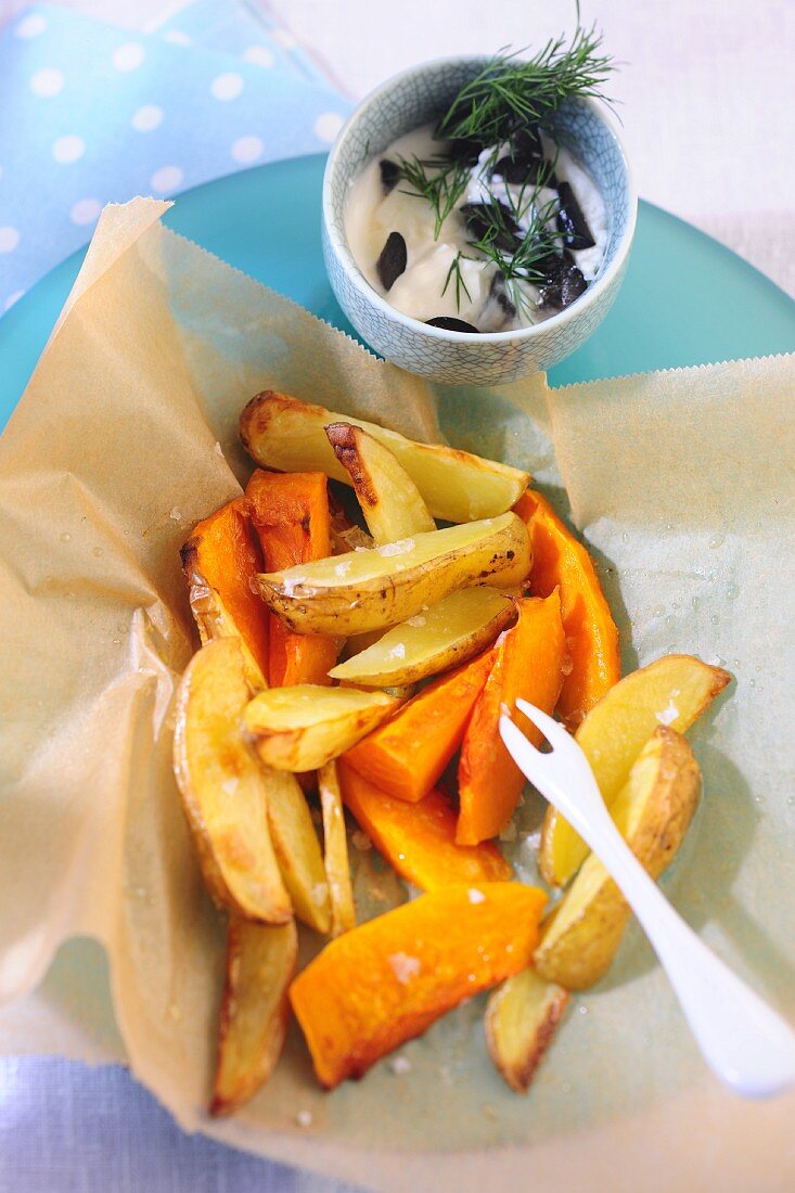 Oven baked pumpkin and potato chips with an olive dip