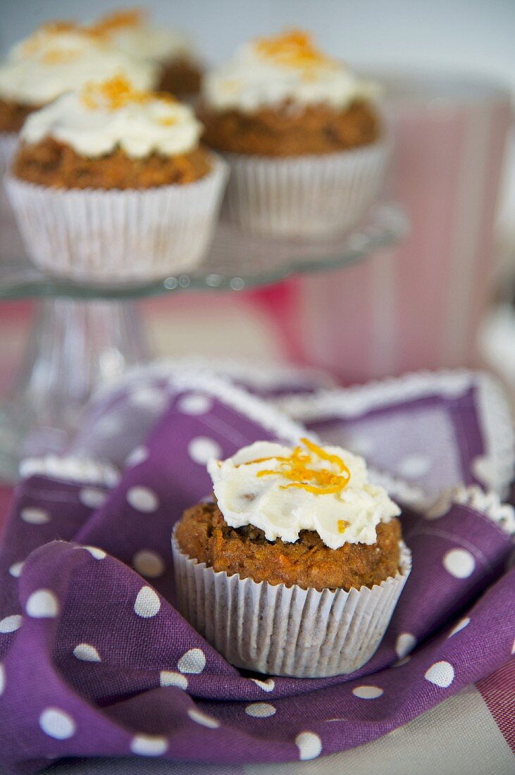 Carrot muffins on a cake stand and on a napkin