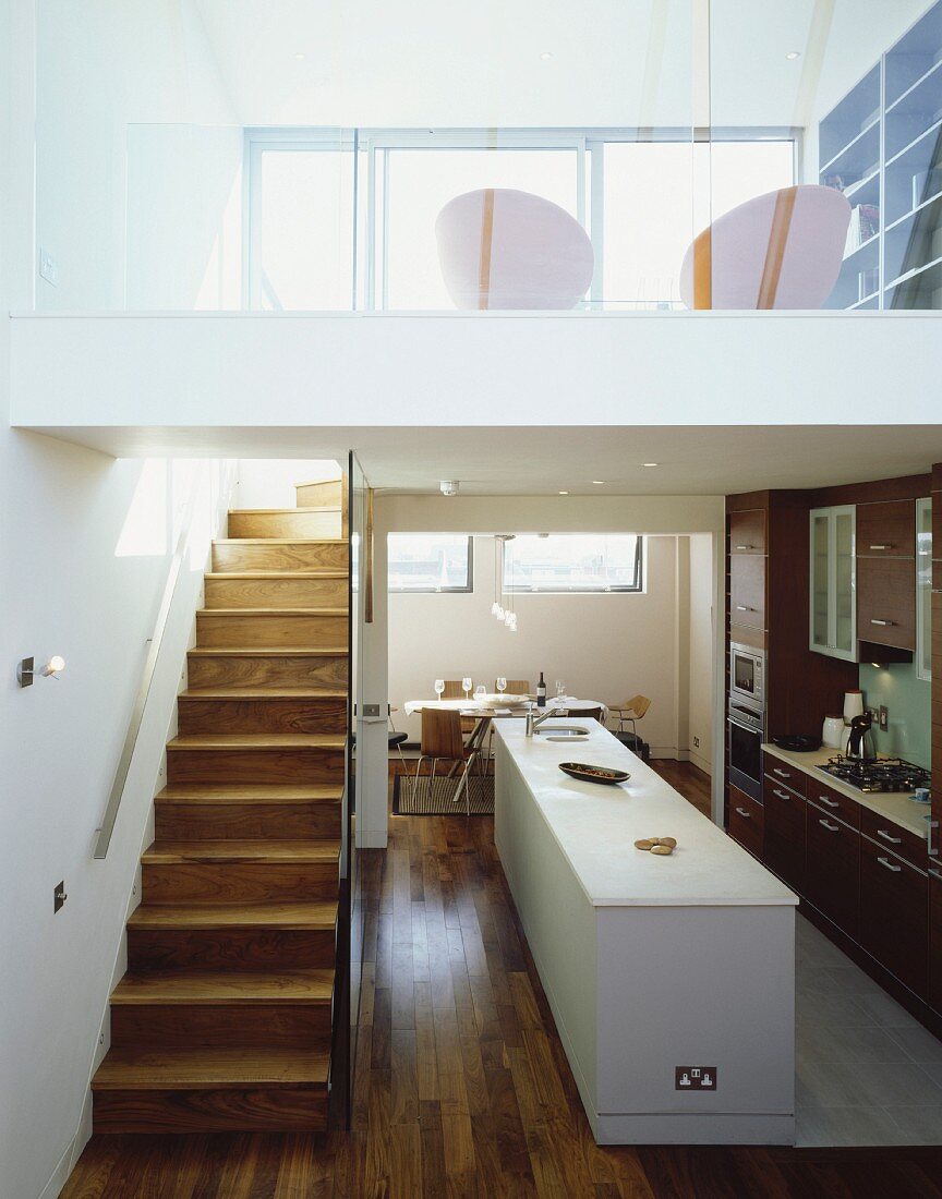 Open-plan living with kitchen area and stairs to gallery