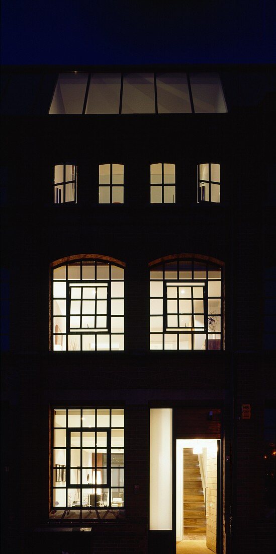 English house with illuminated lattice windows at night
