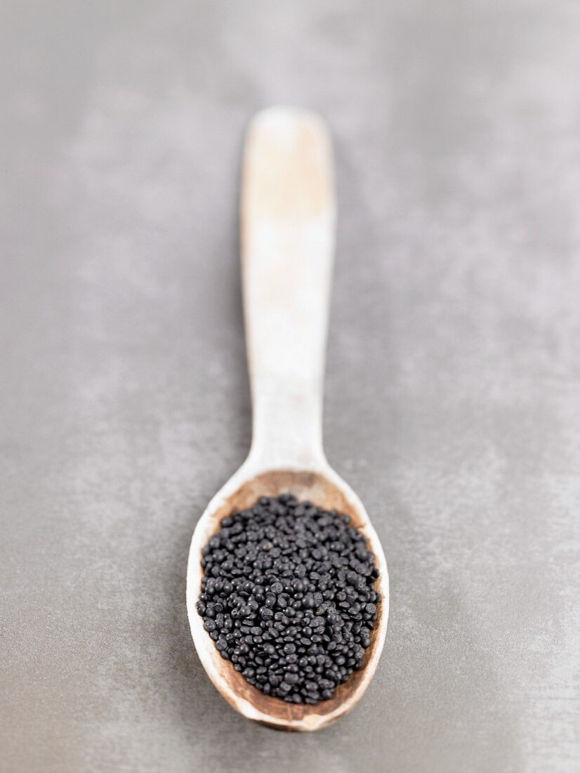 Beluga lentils on a wooden spoon